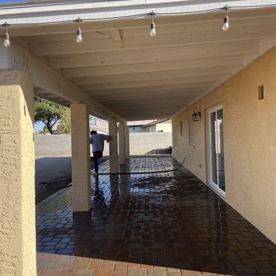 Freshly washed paver patio under a covered patio with string lighting, Arizona City