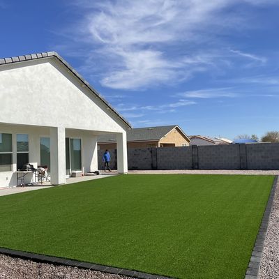Artificial turf backyard bordered in charcoal pavers, Arizona City