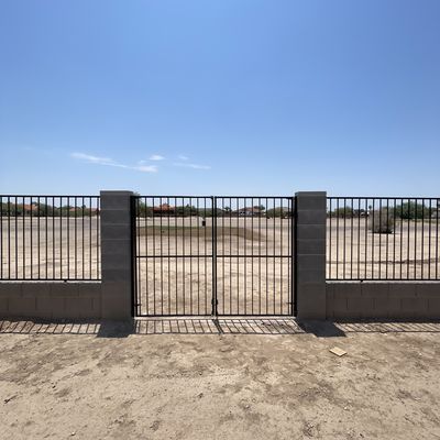Double wrought iron gate between block columns, Arizona City