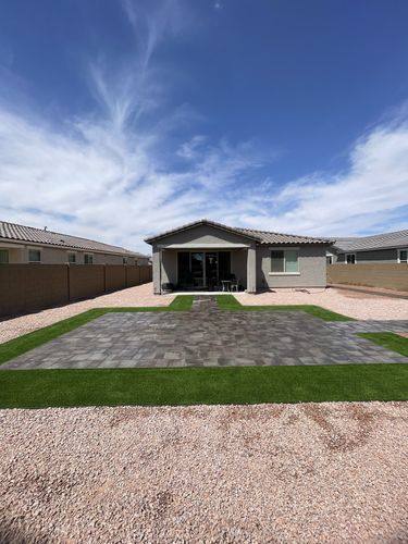 Finished backyard renovation with Belgard paver patio and artificial turf in Casa Grande, AZ