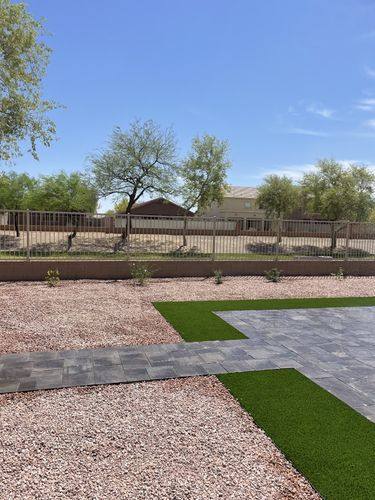 New desert plantings and drip irrigation along the back wall beside the view fence