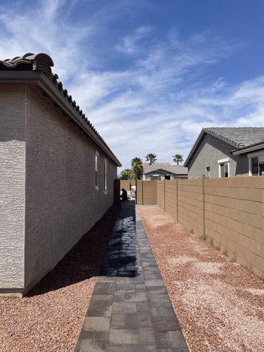 Side yard paver walkway running alongside the house