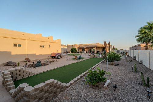 Bocce court seen from the far end, paver walkway alongside