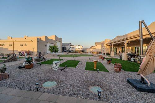 Wide view of the finished courtyard with putting green and turf inlays