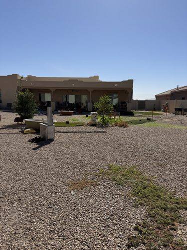 Back of the house before the build, gravel running to the property wall