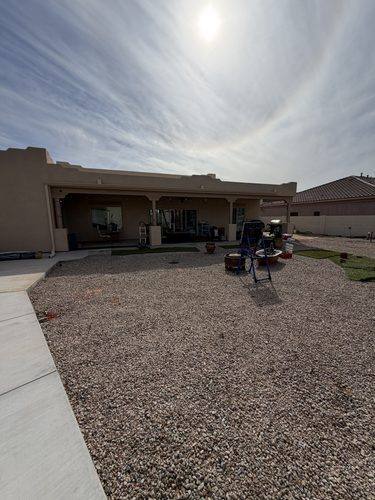 Wide view of the untouched gravel lot before work started