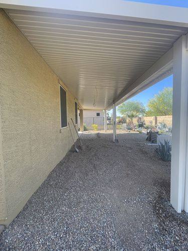 Gravel running the length of the house under the patio cover