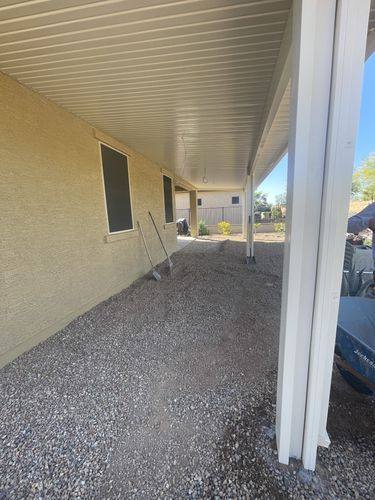 Loose gravel beside the house before the paver patio was built