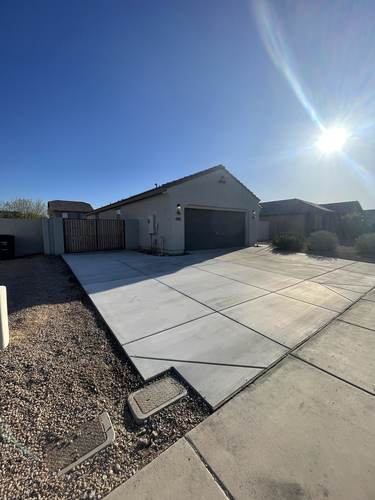 Concrete driveway with iron double gate for side yard access