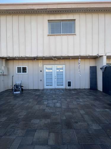 Paver patio installation outside a home's back entrance