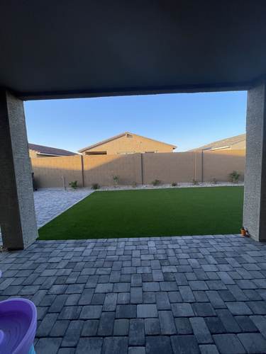 Paver patio viewed from a covered porch