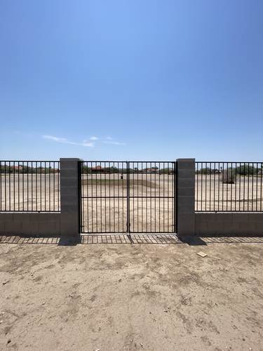 Iron double gate set into a block wall