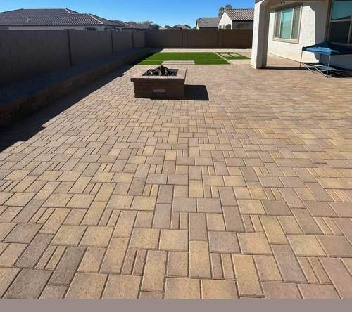 Backyard paver patio with a built-in fire pit
