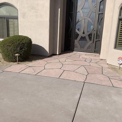 Flagstone entry walkway laid up to a custom iron front door