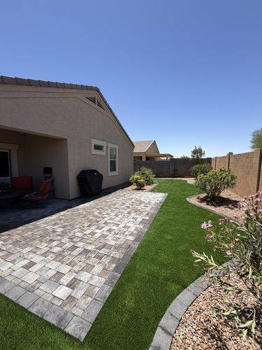 Slate gray Phoenix Pavers meeting Turf Hub Sierra Blend Pro artificial turf