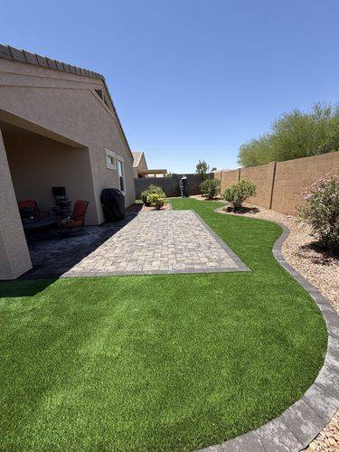 Paver patio running the full length of the covered porch