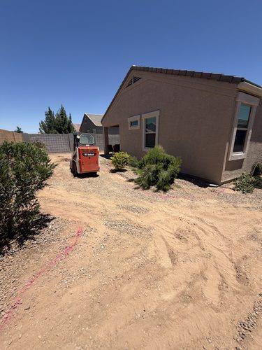 Skid steer working beside the house as the yard was cleared and graded