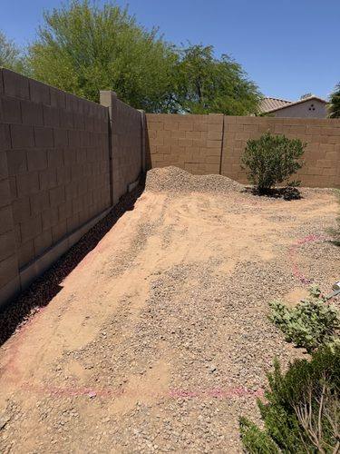 Back corner of the yard cleared and graded before the turf and pavers went in