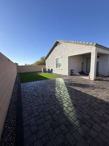 Finished backyard with slate gray Phoenix Pavers and artificial turf in Casa Grande, AZ