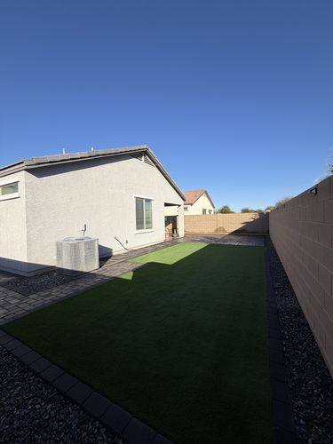 Artificial turf lawn edged with a charcoal paver border