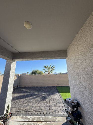 View out from the covered patio across the new pavers and turf