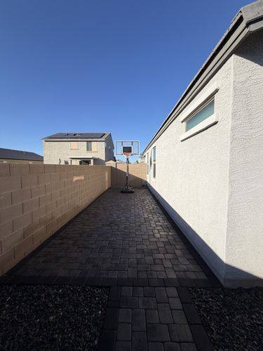 Side yard paved in slate gray pavers with a charcoal border