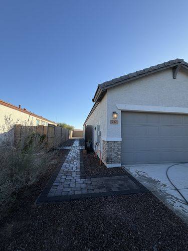 Paver walkway running from the side gate out to the driveway