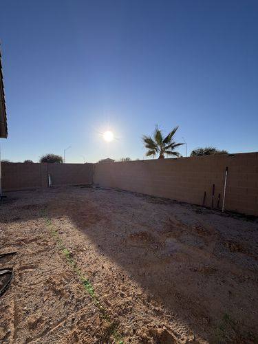 Open dirt lot before renovation looking toward the back block wall