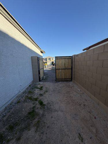 Side yard before renovation, dirt running out to the gate