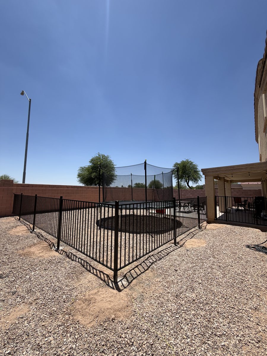 Wrought iron view fence enclosing a backyard play area in Casa Grande
