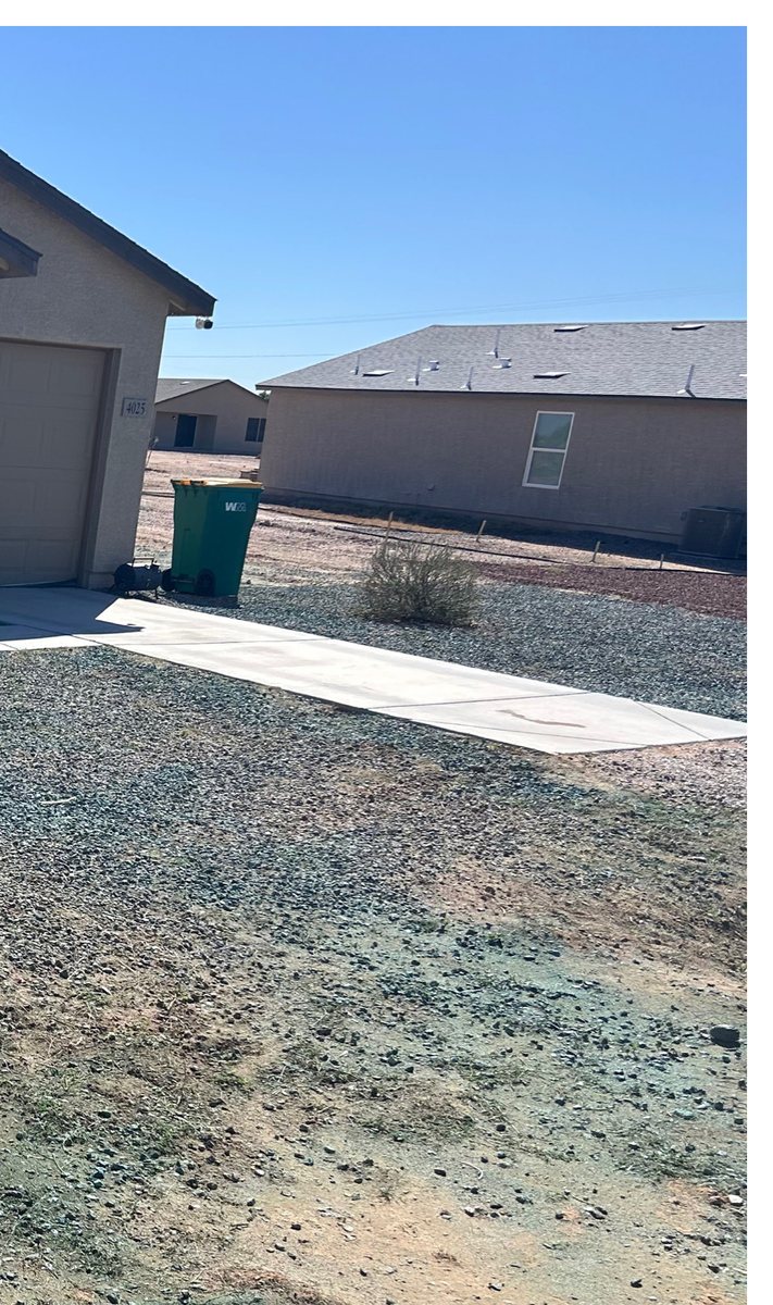 The same lot after weed treatment, with dead weeds and no regrowth