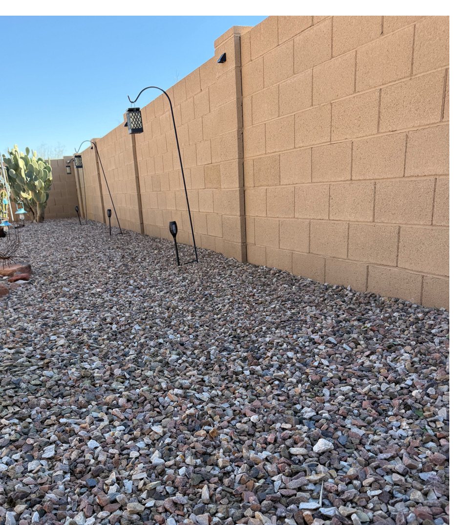 The same gravel strip along the wall cleared of weeds